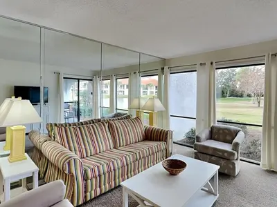 a living room with a couch and a table at Edgewater Villa #703 in Panama City Beach