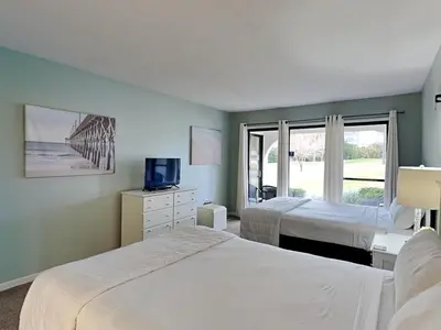 a hotel room with two beds and a window at Edgewater Villa #703 in Panama City Beach