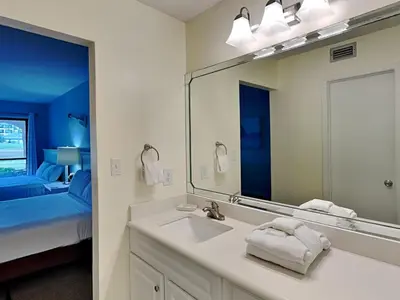 a bathroom with a sink and a mirror at Edgewater Villa #703 in Panama City Beach