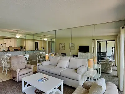 a living room with a couch and a table at Edgewater Villa #703 in Panama City Beach