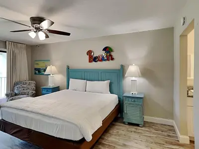 a bedroom with a bed and a ceiling fan at Edgewater Villa #708 in Panama City Beach