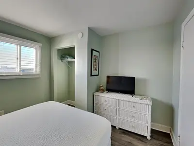 a bedroom with a bed and a tv on a dresser at Summit Beach Resort #901 in Panama City Beach
