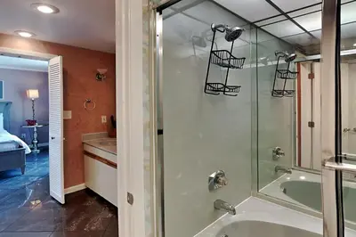 a bathroom with a shower and a tub at Edgewater Tower II 901 in Panama City Beach