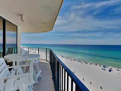 a balcony with a table and chairs and the beach at Edgewater Tower II 801 in Panama City Beach