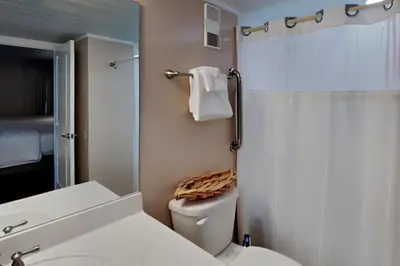 a white bathroom with a toilet and a shower at Edgewater Tower II 801 in Panama City Beach