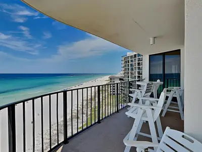 a balcony with chairs and a view of the beach at Edgewater Tower II 801 in Panama City Beach
