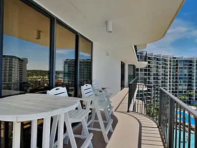 a balcony with a white table and white chairs at Edgewater Tower II 801 in Panama City Beach