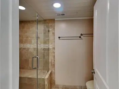 a bathroom with a glass shower with a toilet at Edgewater Tower II 801 in Panama City Beach