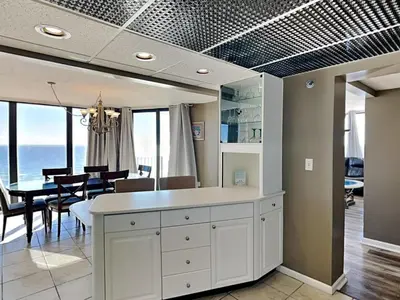 a kitchen and dining room with a table and chairs at Edgewater Tower III 1114 in Panama City Beach