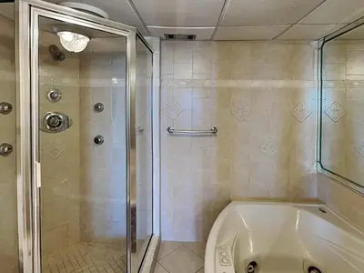 a bathroom with a shower and a bath tub at Edgewater Tower III 1114 in Panama City Beach