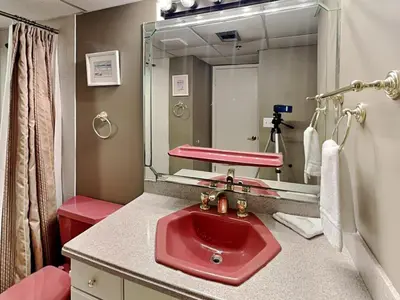 a bathroom with a red sink and a mirror at Edgewater Tower III 1114 in Panama City Beach