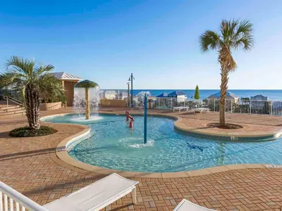 a pool with palm trees and a person playing in it at Laketown Wharf 1907 in Panama City Beach