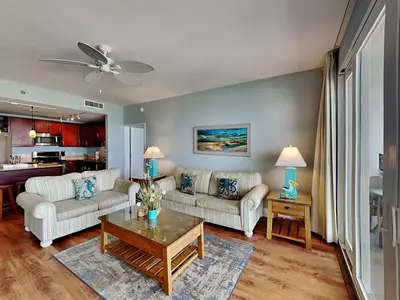 a living room with two couches and a table at Laketown Wharf 1907 in Panama City Beach