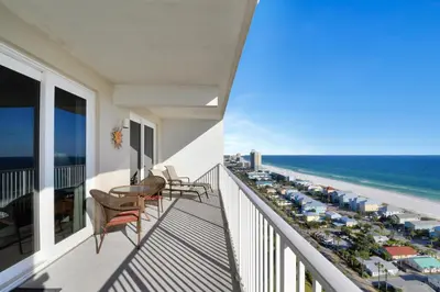 a balcony with a table and chairs and the beach at Laketown Wharf 1907 in Panama City Beach