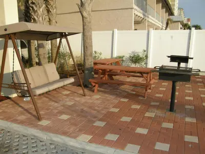a swing and a bench on a patio at Grandview East #1005 in Panama City Beach