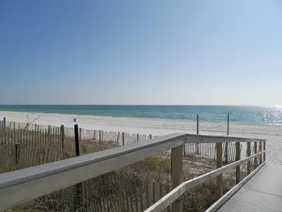 a wooden boardwalk leading to a beach with the ocean at Grandview East #1005 in Panama City Beach