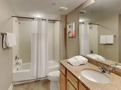 a bathroom with a sink and a toilet and a shower at Grandview East #1005 in Panama City Beach