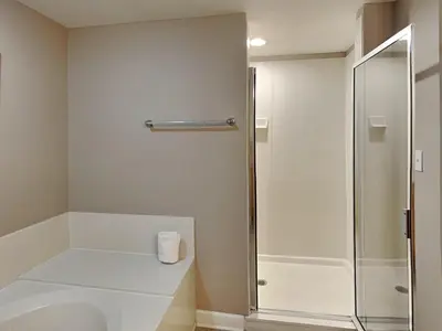 a bathroom with a shower and a roll of toilet paper at Grandview East #1005 in Panama City Beach