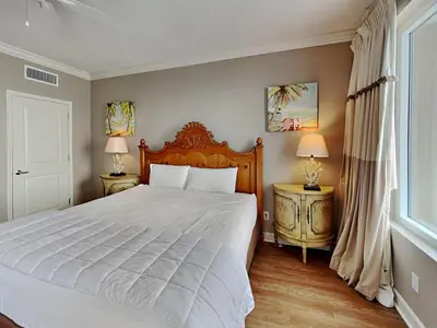 a bedroom with a large bed and two lamps at Grandview East #1005 in Panama City Beach
