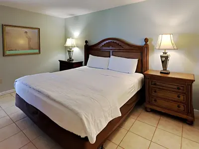 a bedroom with a bed with two night stands and two lamps at Edgewater Tower I 807 in Panama City Beach