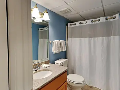 a bathroom with a toilet and a sink and a shower at Edgewater Tower I 807 in Panama City Beach