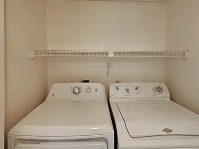a small kitchen with a stove and a shelf at Edgewater Tower I 807 in Panama City Beach