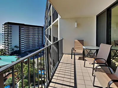 a balcony of a apartment with a table and chairs at Edgewater Tower I 907 in Panama City Beach