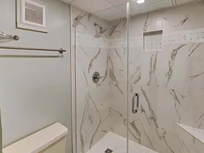 a bathroom with a shower with a glass door at Edgewater Tower I 1010 in Panama City Beach