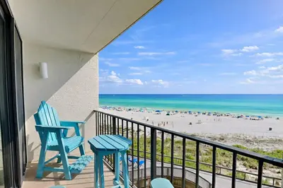 a balcony with two chairs and a view of the beach at Edgewater Tower II in Panama City Beach