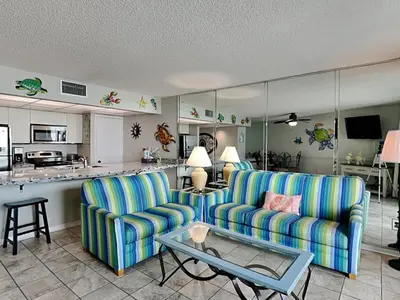a living room with two chairs and a table at Edgewater Tower II in Panama City Beach