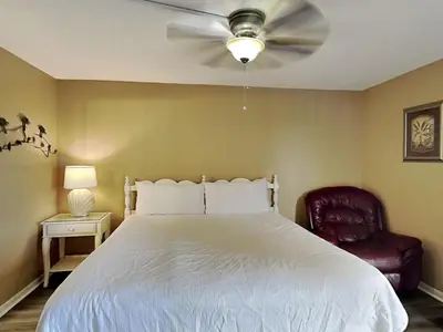 a bedroom with a white bed and a ceiling fan at Edgewater Tower II in Panama City Beach