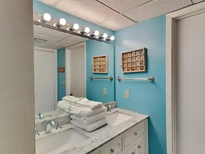 a bathroom with a sink and a mirror at Edgewater Tower II in Panama City Beach