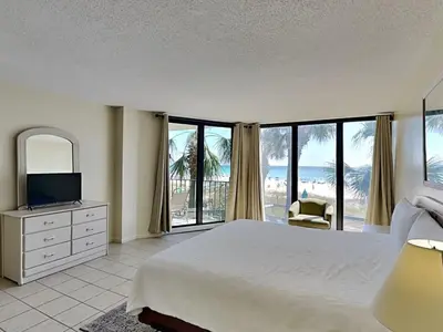 a bedroom with a bed and a view of the ocean at Edgewater Tower II 110 in Panama City Beach