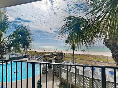 a balcony with a view of a beach and a pool at Edgewater Tower II 110 in Panama City Beach