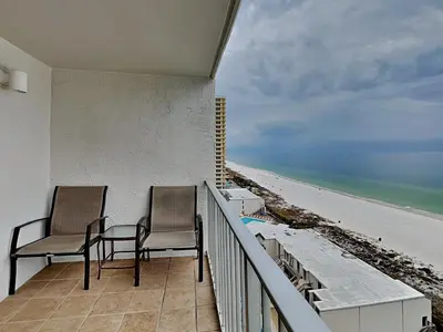 two chairs on a balcony with a view of the beach at Summit Beach Resort 1230 in Panama City Beach