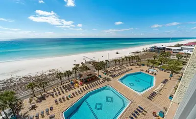 an aerial view of the beach and swimming pools at the resort at Summit Beach Resort #821 in Panama City Beach