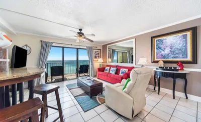 a living room with a red couch and a table at Summit Beach Resort #821 in Panama City Beach