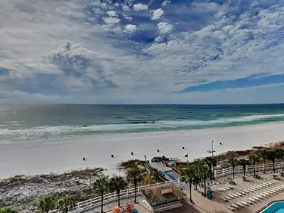 a beach with people on the sand and the ocean at Summit Beach Resort #821 in Panama City Beach
