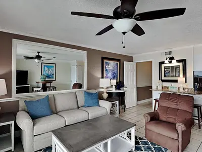 a living room with a couch and a ceiling fan at Summit Beach Resort #821 in Panama City Beach