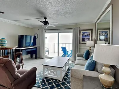 a living room with a couch and a table at Summit Beach Resort #821 in Panama City Beach