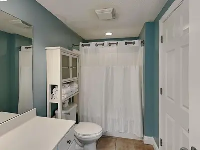 a bathroom with a white toilet and a shower at Majestic Beach Towers II #2005 in Panama City Beach