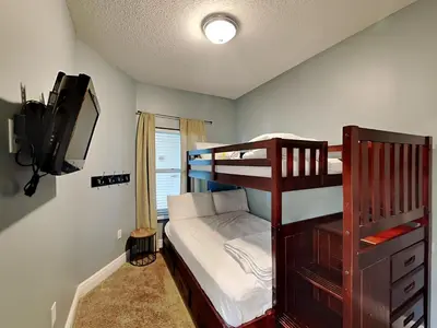 a bedroom with a bunk bed and a television at Majestic Beach Towers II #2005 in Panama City Beach