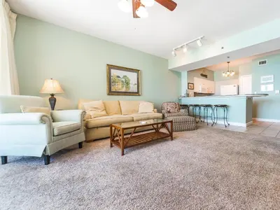 a living room with a couch and a table at Shores of Panama #1111 in Panama City Beach