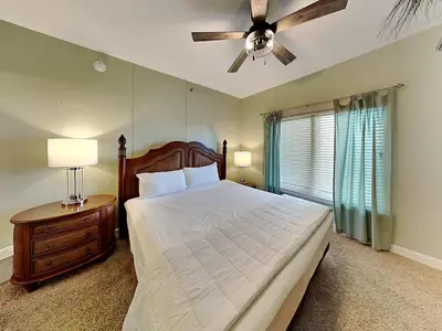 a bedroom with a bed and a ceiling fan at Shores of Panama #1510 in Panama City Beach