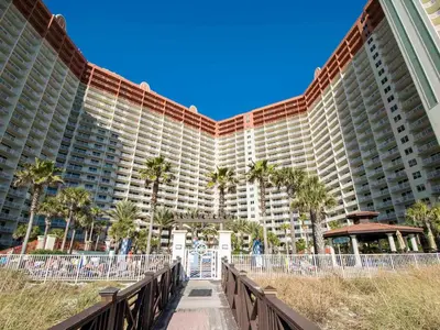 a large building with palm trees in front of it at Shores of Panama #1510 in Panama City Beach
