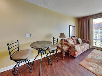 a living room with a couch and a table and chairs at Shores of Panama #1908 in Panama City Beach