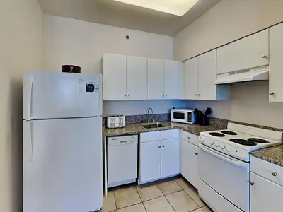 a kitchen with white appliances and a white refrigerator at Shores of Panama #1706 in Panama City Beach