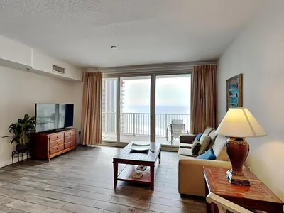 a living room with a couch and a television at Shores of Panama #1611 in Panama City Beach