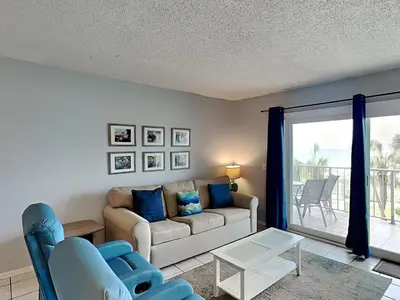 a living room with a couch and a table at Summit Beach Resort 330 in Panama City Beach