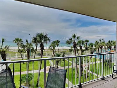 a balcony with palm trees and a view of the ocean at Summit Beach Resort 330 in Panama City Beach